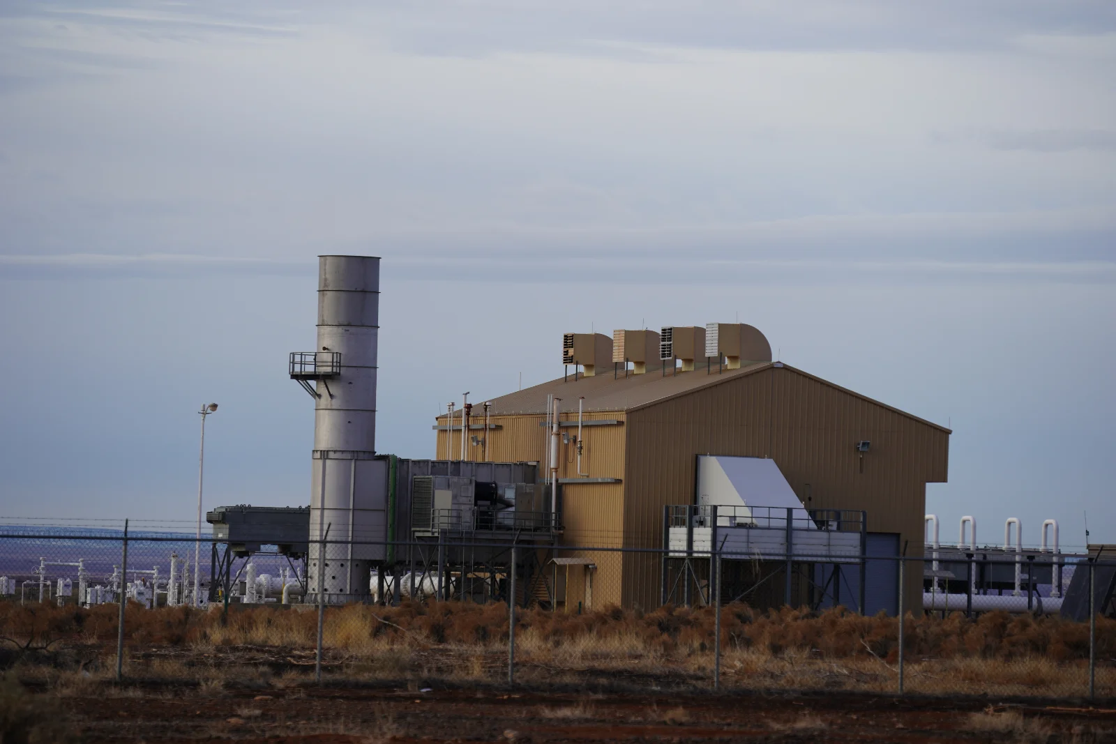 A natural gas transmission pipeline compressor station with turbine exhaust stack