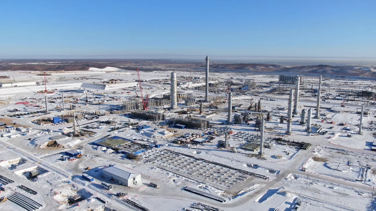 Aerial view of the Amur Gas Chemical Complex under construction in winter, showing the pyrolysis unit area with process columns and cranes